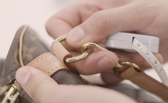 Expert Kevin Ngo Inspects The Hardware On A Louis Vuitton Speedy Bag