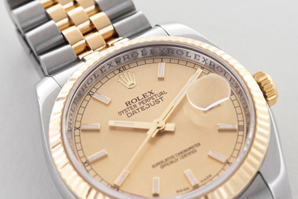 Rolex Datejust with focus on repeating Rolex text on rehaut ring