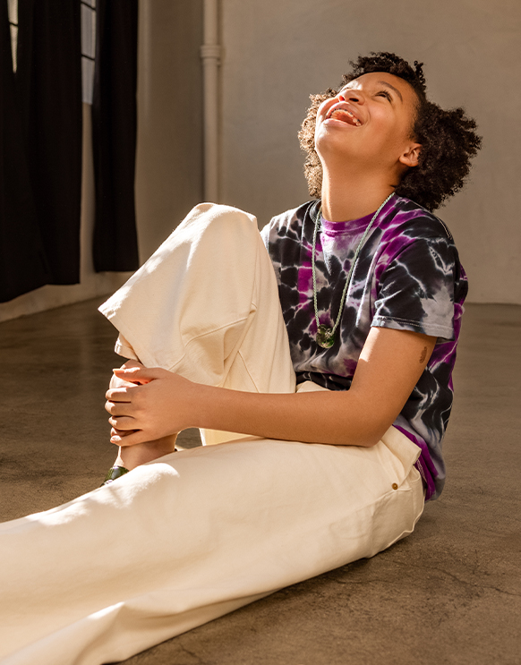 International Women's Day 2021: Jordyn, a 12-year-old Black Girls Code student in Los Angeles looking up. She wears a printed t-shirt and jeans.