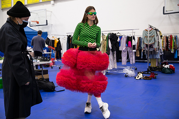 stylist Malina Joseph Gilchrist working with model, Elle Dawson. Photograph by Lewis Mirrett. Molly Goddard dress and hoodie, Celine sneakers. 